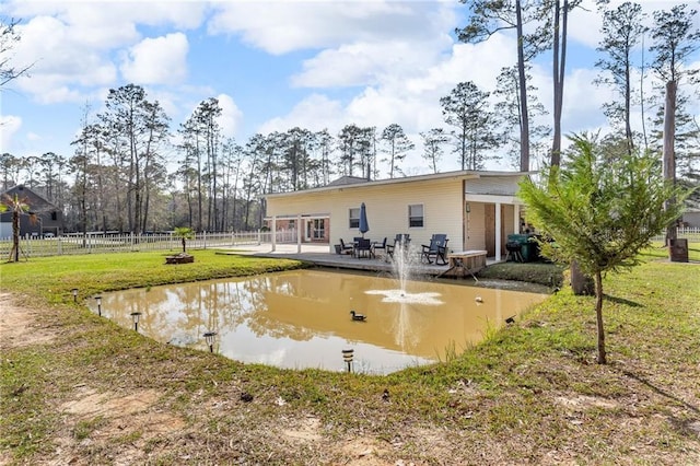 back of house with fence and a lawn