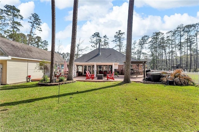 31501 River Pines Dr, Springfield, LA 70462 - rear view of house featuring a hot tub, a lawn, and a patio area