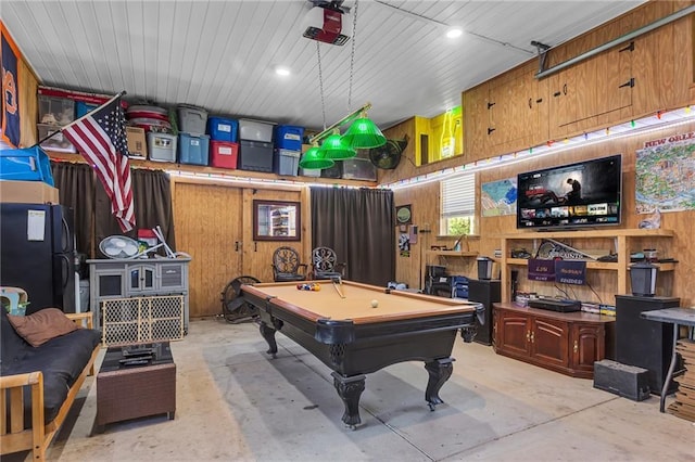 playroom featuring billiards, wooden walls, and concrete floors