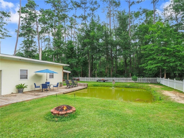 31501 River Pines Dr, Springfield, LA 70462 - view of yard featuring a fenced backyard, a fire pit, and a deck