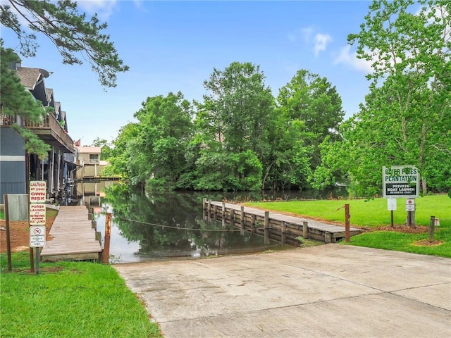 dock area featuring a yard and a water view