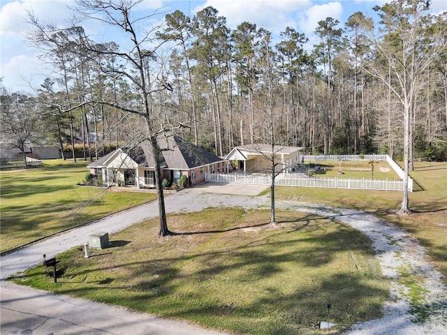 view of yard featuring dirt driveway and fence