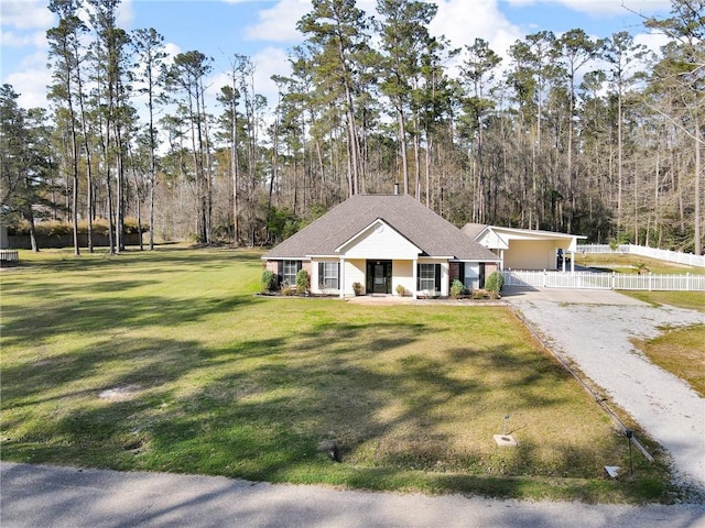 31501 River Pines Dr, Springfield, LA 70462 - view of front of property featuring a porch, a front lawn, fence, and driveway