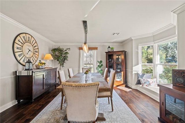 dining room with a wealth of natural light, visible vents, dark wood-style flooring, and ornamental molding