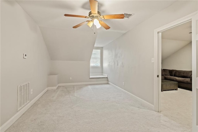 additional living space featuring visible vents, lofted ceiling, carpet, and ceiling fan