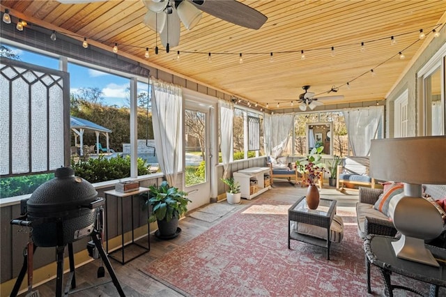 sunroom with track lighting, wooden ceiling, and ceiling fan