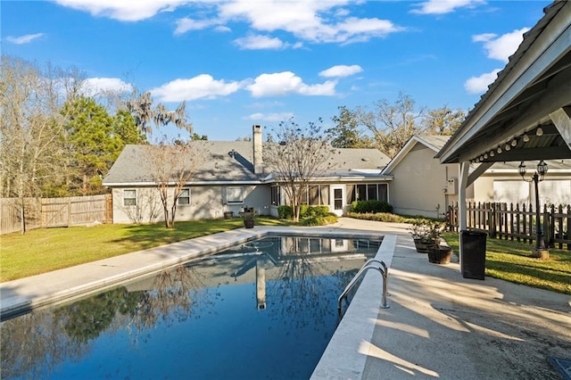 view of pool with a patio area, a lawn, a fenced in pool, and fence