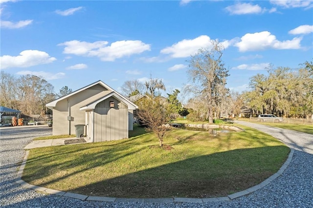 exterior space with an outdoor structure and a lawn