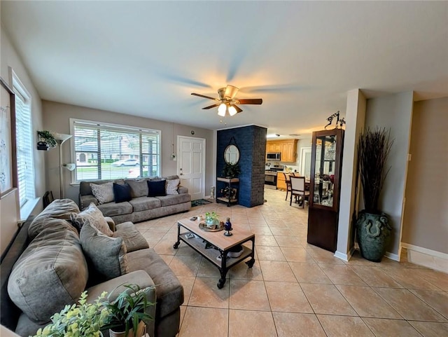 living area featuring baseboards, ceiling fan, and light tile patterned flooring
