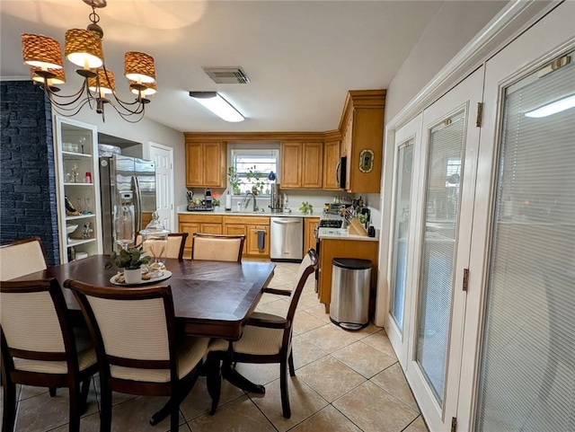 dining space featuring light tile patterned flooring, visible vents, and a notable chandelier