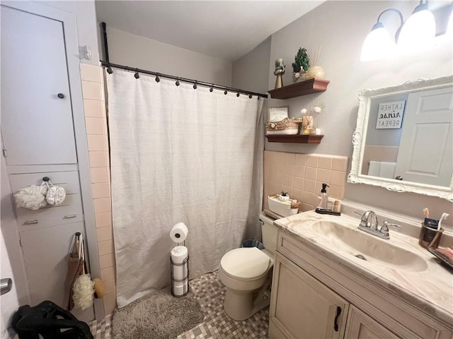 bathroom featuring toilet, a shower with curtain, vanity, and tile walls