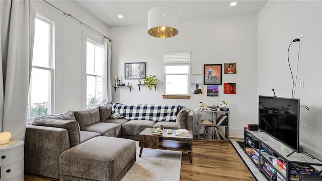 living room with a wealth of natural light, wood finished floors, and recessed lighting