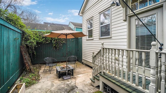 view of patio / terrace with a fire pit and a fenced backyard