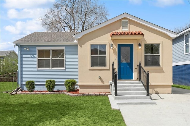 view of front of property with a front lawn and fence