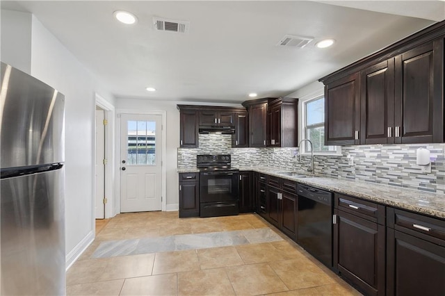 kitchen featuring black appliances, visible vents, under cabinet range hood, and a sink