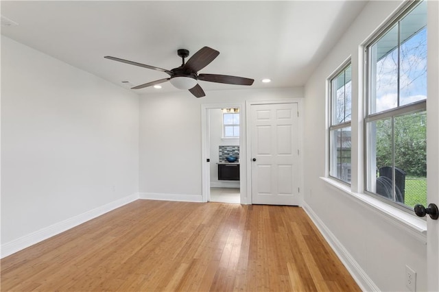 unfurnished room with light wood finished floors, recessed lighting, a ceiling fan, and baseboards