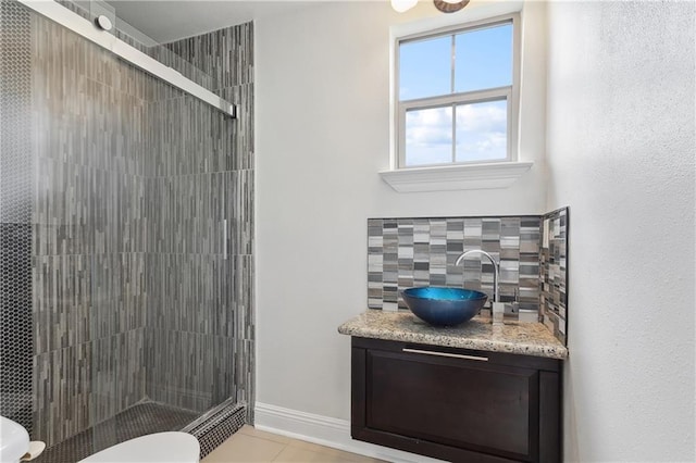 full bath with vanity, a shower stall, toilet, and decorative backsplash