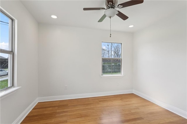 empty room with light wood-style flooring, plenty of natural light, recessed lighting, and baseboards