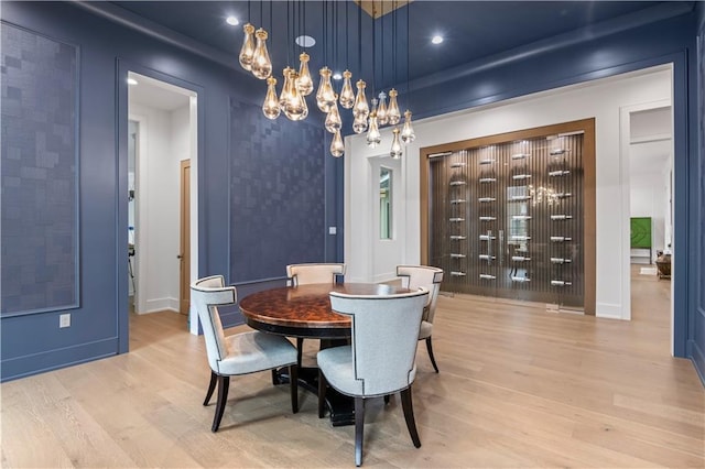 dining area featuring recessed lighting, baseboards, an inviting chandelier, and light wood-style flooring