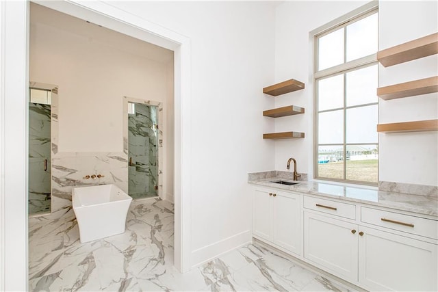 bar with wet bar, baseboards, marble finish floor, and a sink