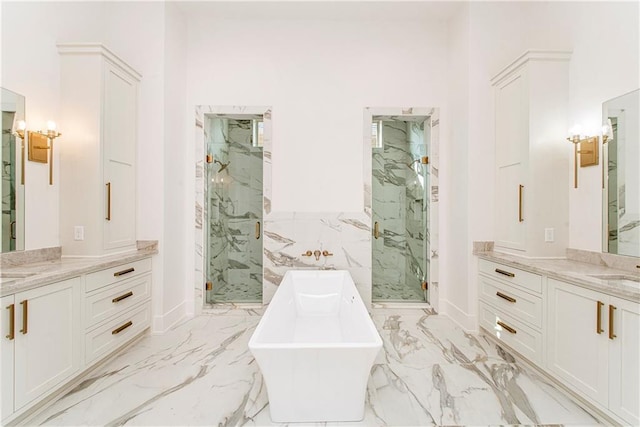 bathroom featuring a marble finish shower, marble finish floor, two vanities, and a freestanding tub