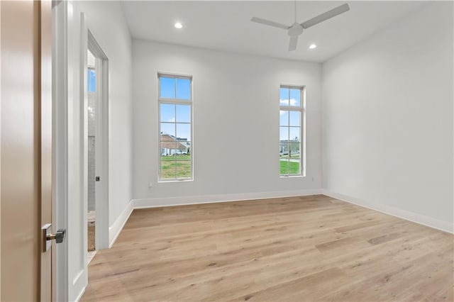 spare room with light wood finished floors, recessed lighting, and a wealth of natural light