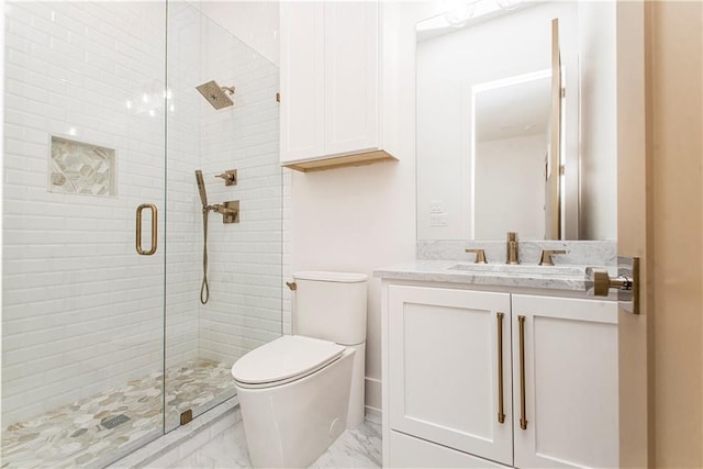 bathroom featuring vanity, toilet, marble finish floor, and a shower stall