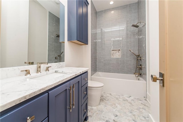 bathroom featuring toilet, vanity, and  shower combination