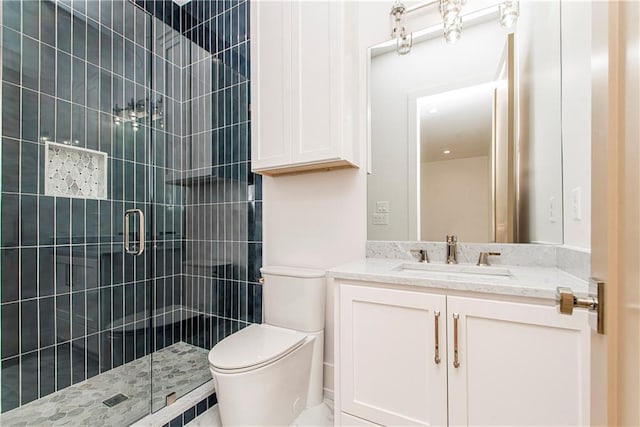 full bathroom featuring vanity, toilet, and a stall shower