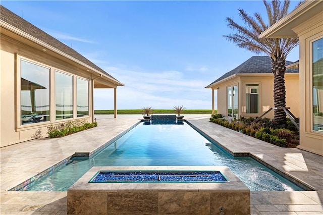 pool featuring a patio and an in ground hot tub