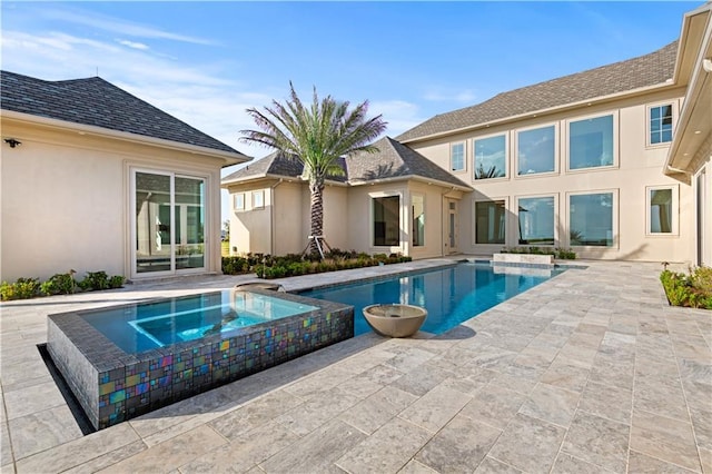 view of swimming pool with a patio area and a pool with connected hot tub