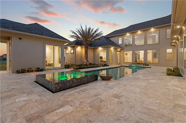 view of pool with a patio area and a pool with connected hot tub