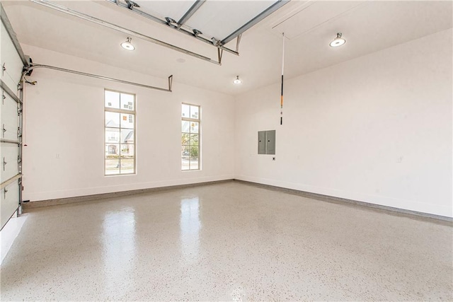 garage with electric panel and baseboards