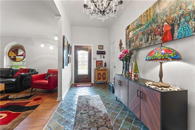 foyer with dark wood-style floors, a notable chandelier, crown molding, and baseboards