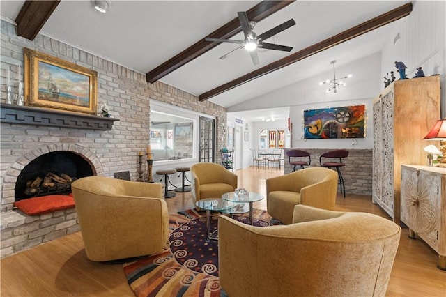 living room with beamed ceiling, visible vents, wood finished floors, a brick fireplace, and ceiling fan