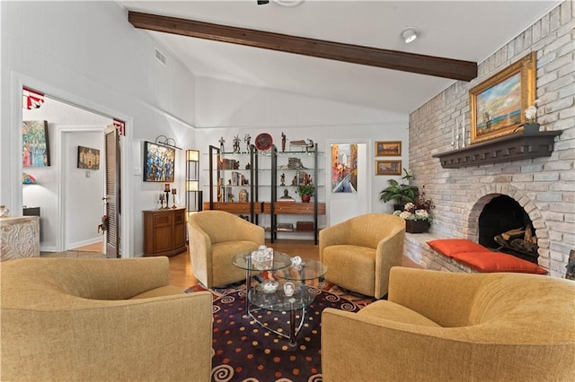 living room featuring visible vents, a brick fireplace, vaulted ceiling with beams, and wood finished floors