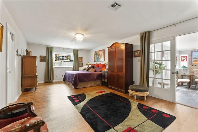 bedroom featuring visible vents and light wood-style floors