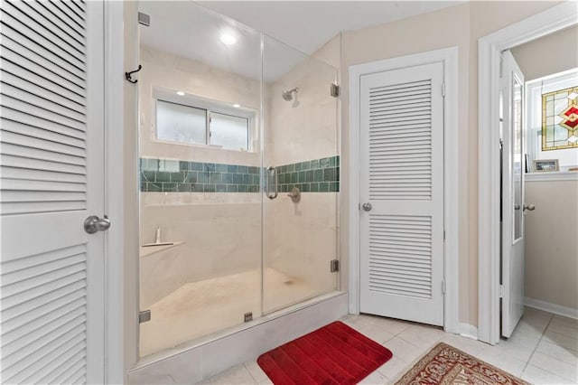 full bathroom featuring a closet, a shower stall, and tile patterned flooring