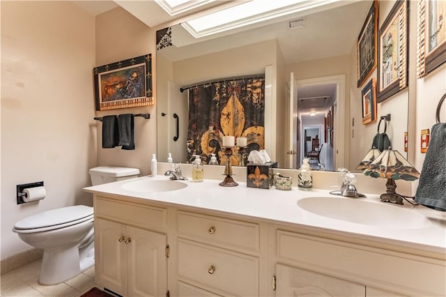 full bathroom featuring tile patterned floors, double vanity, toilet, and a sink