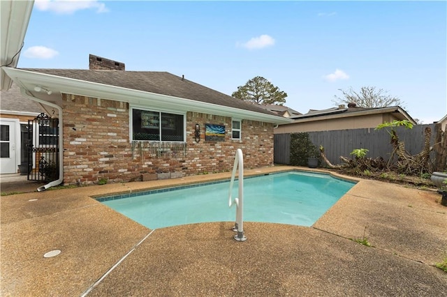 view of swimming pool with a patio area, fence, and a fenced in pool