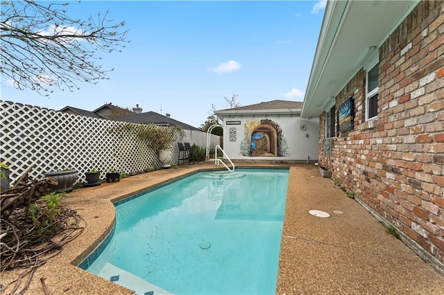 view of pool with a fenced in pool and fence