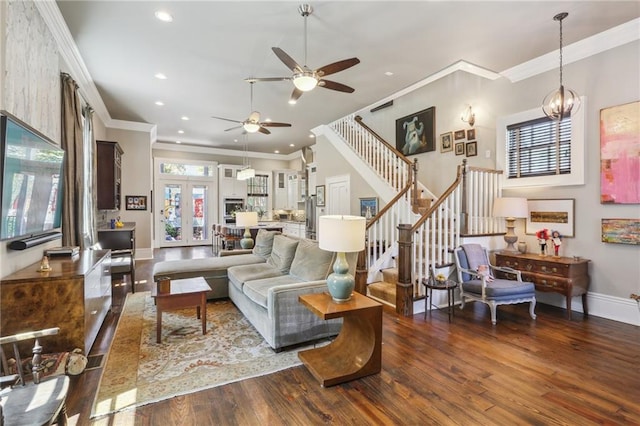 living room with stairway, wood finished floors, a ceiling fan, and crown molding