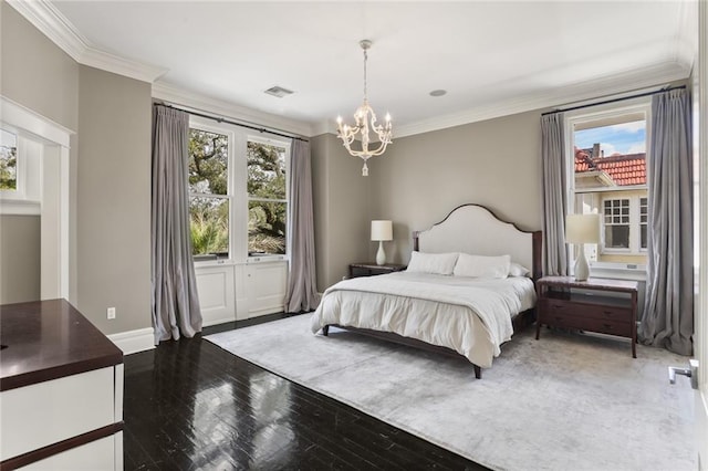 bedroom featuring multiple windows, wood finished floors, a chandelier, and ornamental molding