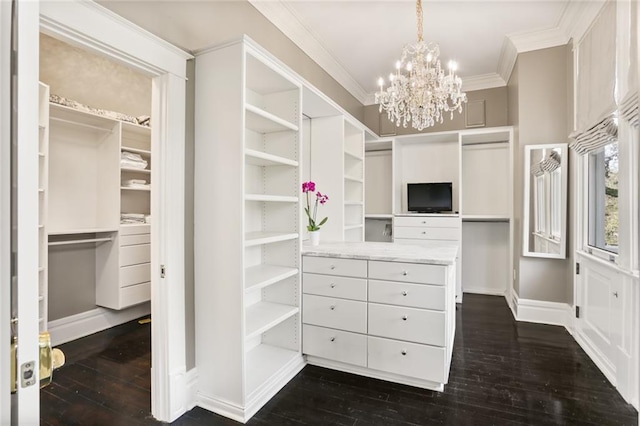 walk in closet with a chandelier and dark wood-style floors