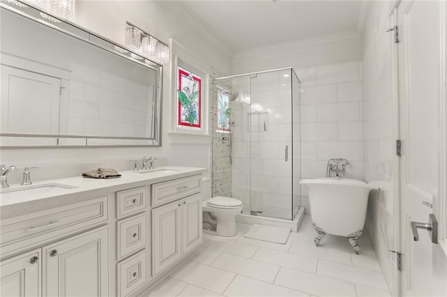 bathroom with a sink, a freestanding tub, ornamental molding, and a shower stall