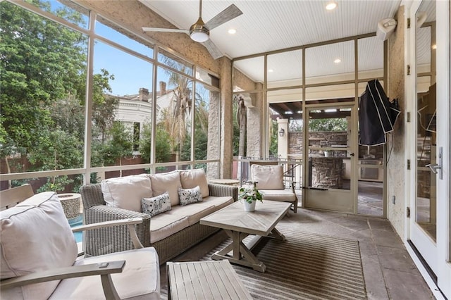 unfurnished sunroom with a ceiling fan