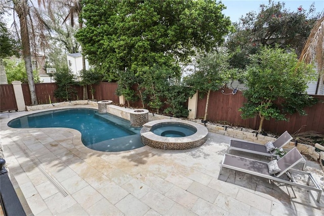 view of pool featuring a pool with connected hot tub, a fenced backyard, and a patio area