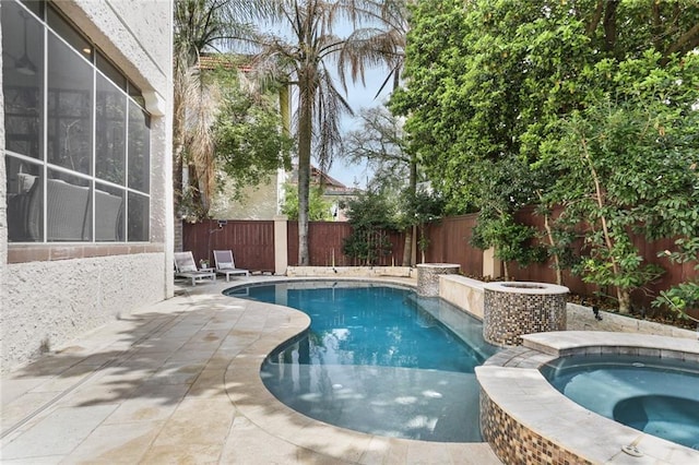 view of swimming pool featuring an in ground hot tub, a fenced in pool, a fenced backyard, and a patio area