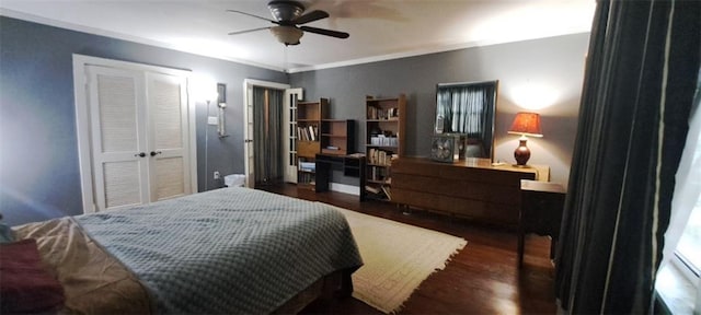 bedroom featuring a ceiling fan, wood finished floors, a closet, and ornamental molding