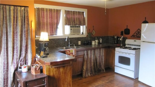 314 Halsey Dr, Harahan, LA 70123 - kitchen with backsplash, a sink, white appliances, brown cabinetry, and dark wood-style flooring